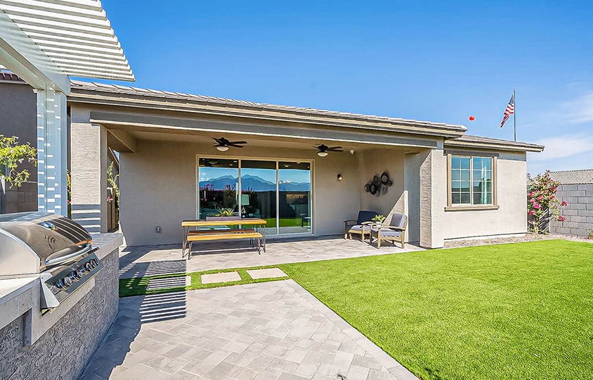 Castellano model home rear yard covered patio by Brightland Homes at Alamar community in Avondale, AZ